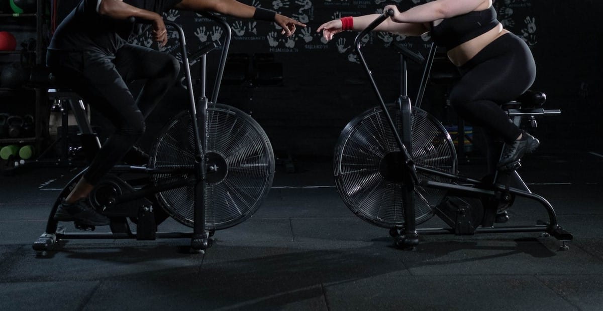 Man and Woman Exercising Using a Stationary Bicycle