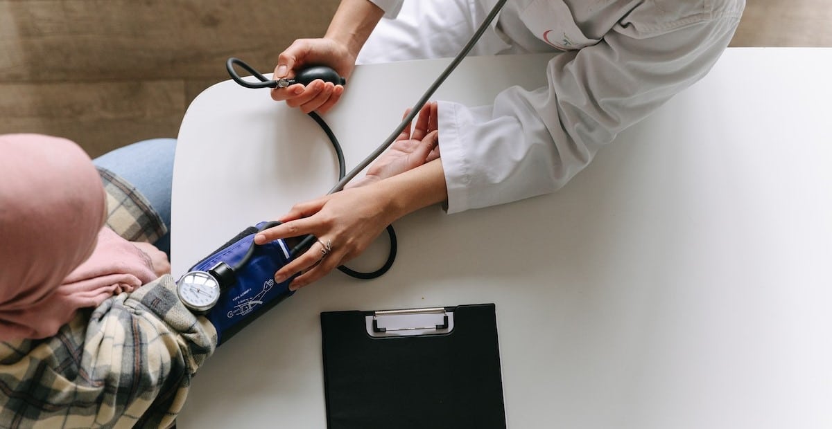 A Doctor Taking Patient's Blood Pressure