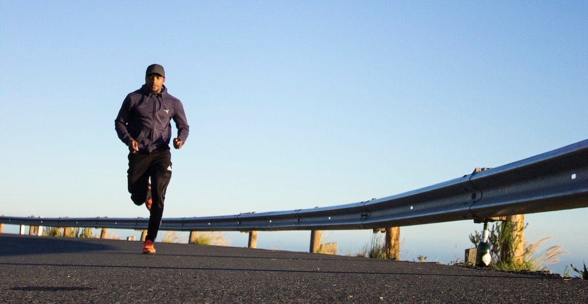 A man running on a road during daytime