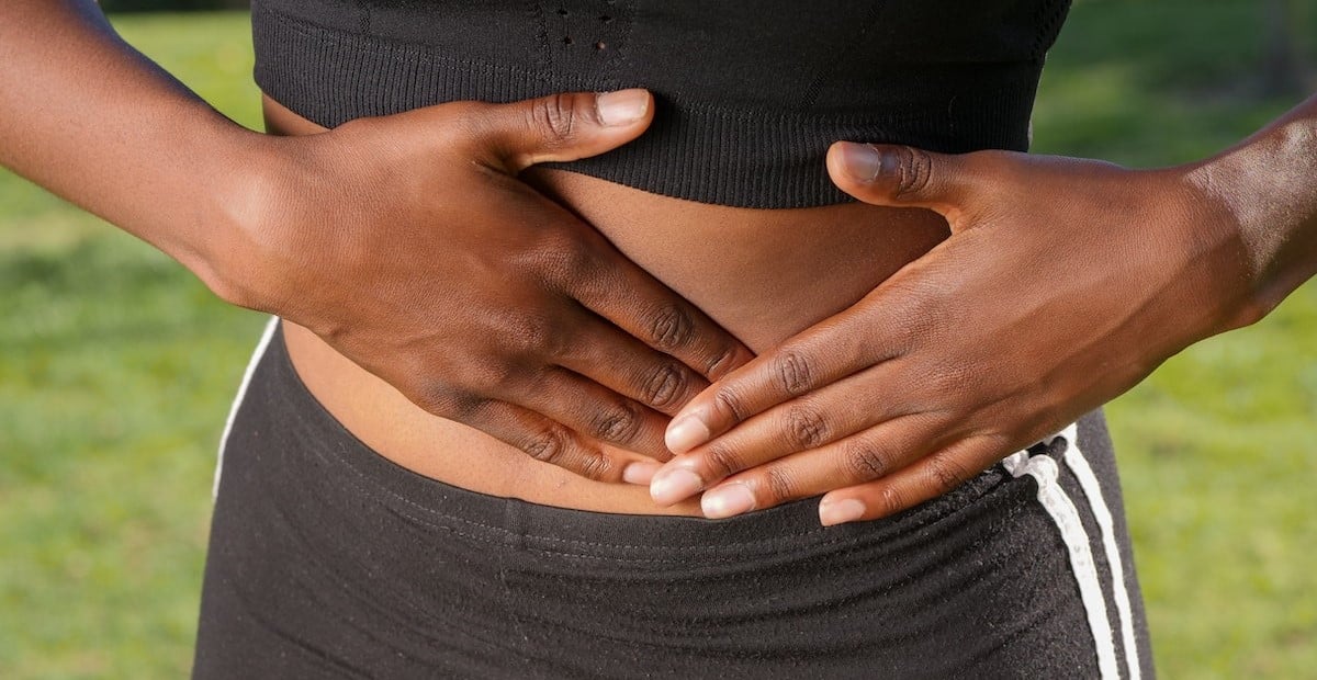 A woman touching her abdomen
