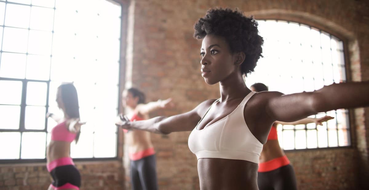 A woman training with other sportswomen in a fitness studio