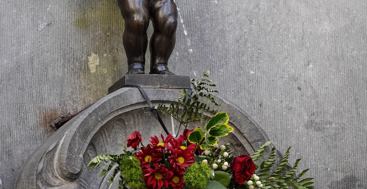 Concrete Statue Near Flowers