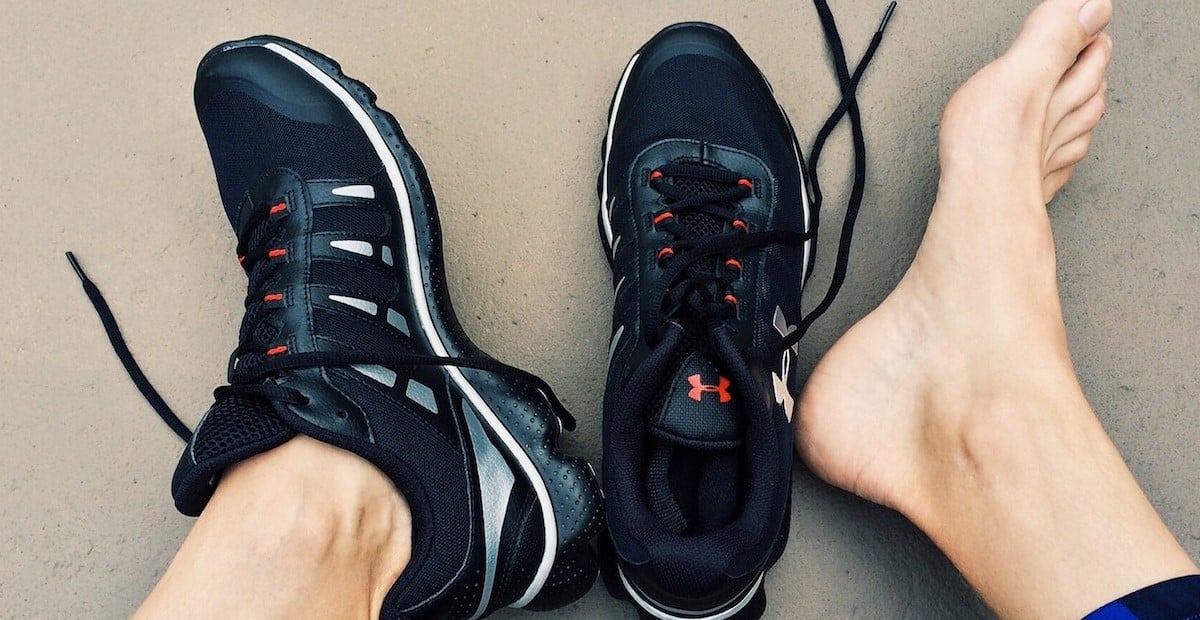 An runner with one shoe on and one bare foot.