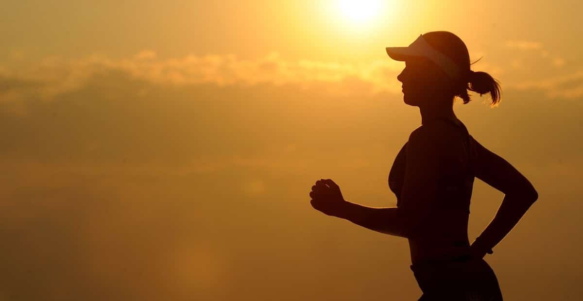 A woman with sunvisor running