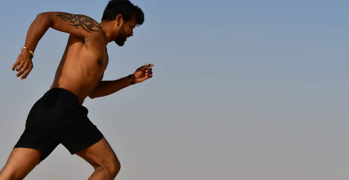 A sportsman jogging on bright day